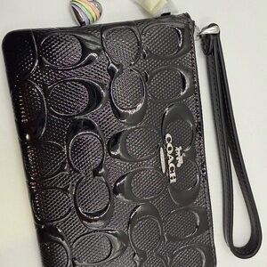 Coach black signature print wristlet with heart charm
